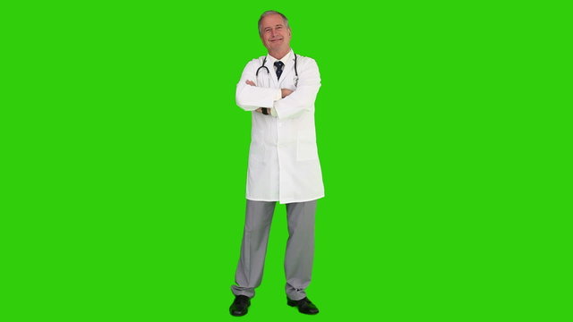 Mature doctor with a stethoscope looking at the camera