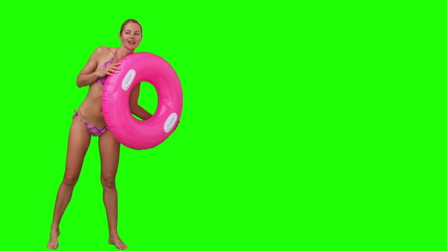 Woman in swimsuit playing with a rubber ring