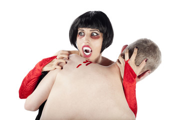 Spooky vampire woman biting a man