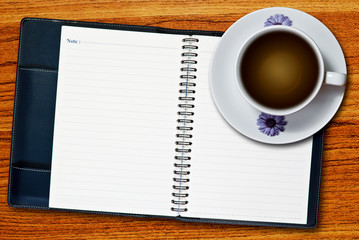 Obraz na płótnie Canvas white cup of coffee and notebook