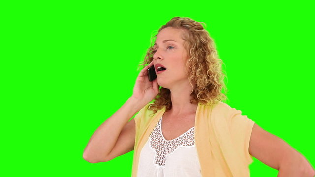 Curly blond haired woman having a phone call
