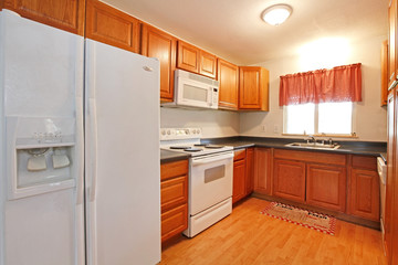 Fototapeta premium Simple kitchen with white appliances