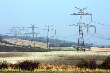 high voltage transmission towers in line