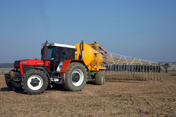 red tractor with yellow sprayer tank
