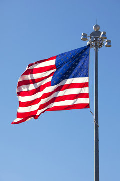 United States Flag in front of clear blue sky