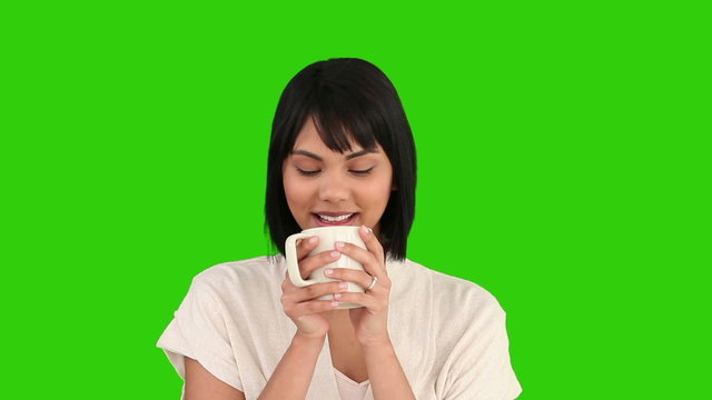 Asian woman drinking a cup of tea