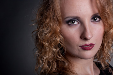 Naklejka premium Young gorgeous model in a lace dress, a black background