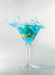 splashing on blue martini on white stock photo