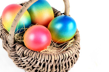 Colorful painted easter eggs in brown basket