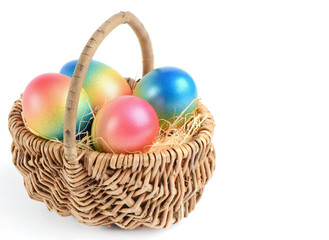 Colorful painted easter eggs in brown basket