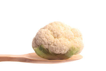 Mini cauliflower on a wooden spoon