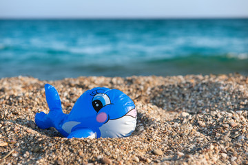 Fototapeta na wymiar Funny toy fish at the beach