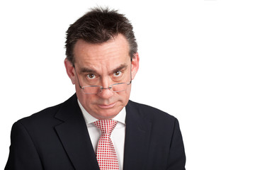 Stern Businessman looking over Spectacles