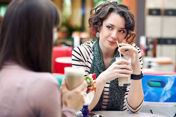 Two young women having lunch break together