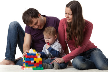 Naklejka premium Happy family with baby build house.
