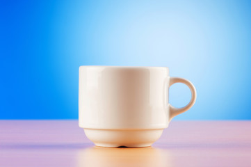 White cup against colourful gradient on the table