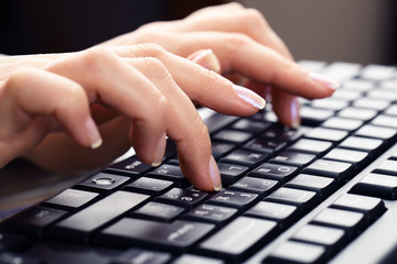 Typing on keyboard.