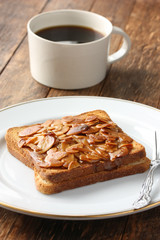 a cup of coffee and toast with almond slices