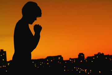 Fototapeta na wymiar Female Silhouette In Prayer