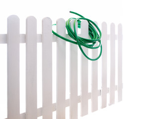 water hose on the wooden fence