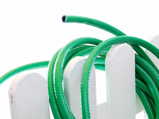 water hose on the wooden fence