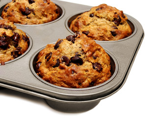 A tray of freshly baked muffins on white