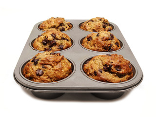 A tray of freshly baked muffins on white