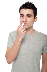 Young man applying lip balm