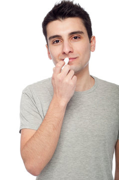 Young Man Applying Lip Balm