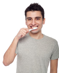 Young man brushing teeth