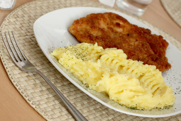 wet homemade fried chicken steak and boiled potatoes