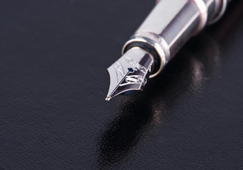 Ink pen on black background