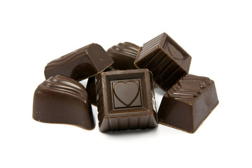 dark assorted chocolate pralines on white background