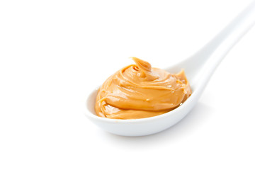 Creamy peanut butter in a white spoon