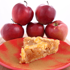 Apple Pie - a slice with cinnamon and some red apples