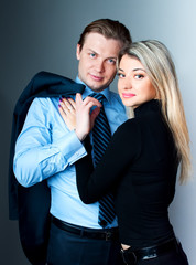 Beautiful modern young couple on the gray background