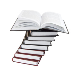Open book on a pile of books
