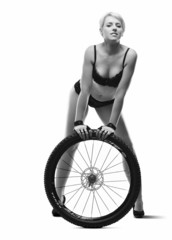 Young, beautiful woman with bicycle wheel