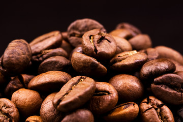 Heap of burnt brown arabica coffee beans