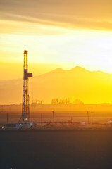 Sunset on an oilrig and the Rocky Mountains
