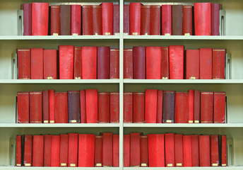 red old hardcover books on shelf