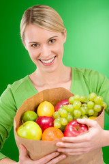 Healthy lifestyle - woman with fruit shopping paper bag