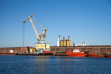 Floating crane standing on the waterfront of the port.