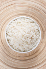 Rice in a bowl on a bamboo plate