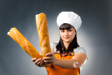 woman cook holding breaked french bread