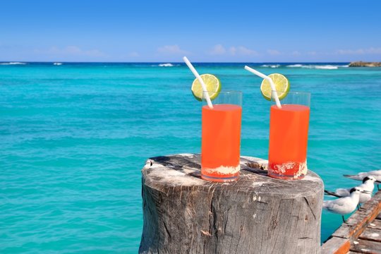beach orange cocktail in Caribbean turquoise sea