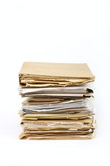 Stack of old paper files isolated on white background