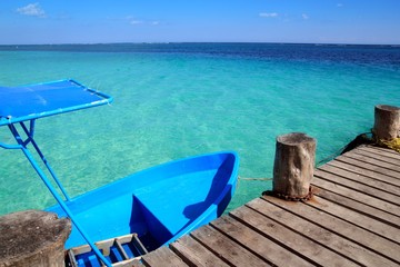 blue boat in wooden tropical pier in Caribbean