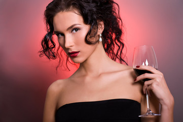 Beautiful young woman with glass of red wine