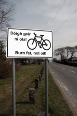 burn fat not oil irish road sign